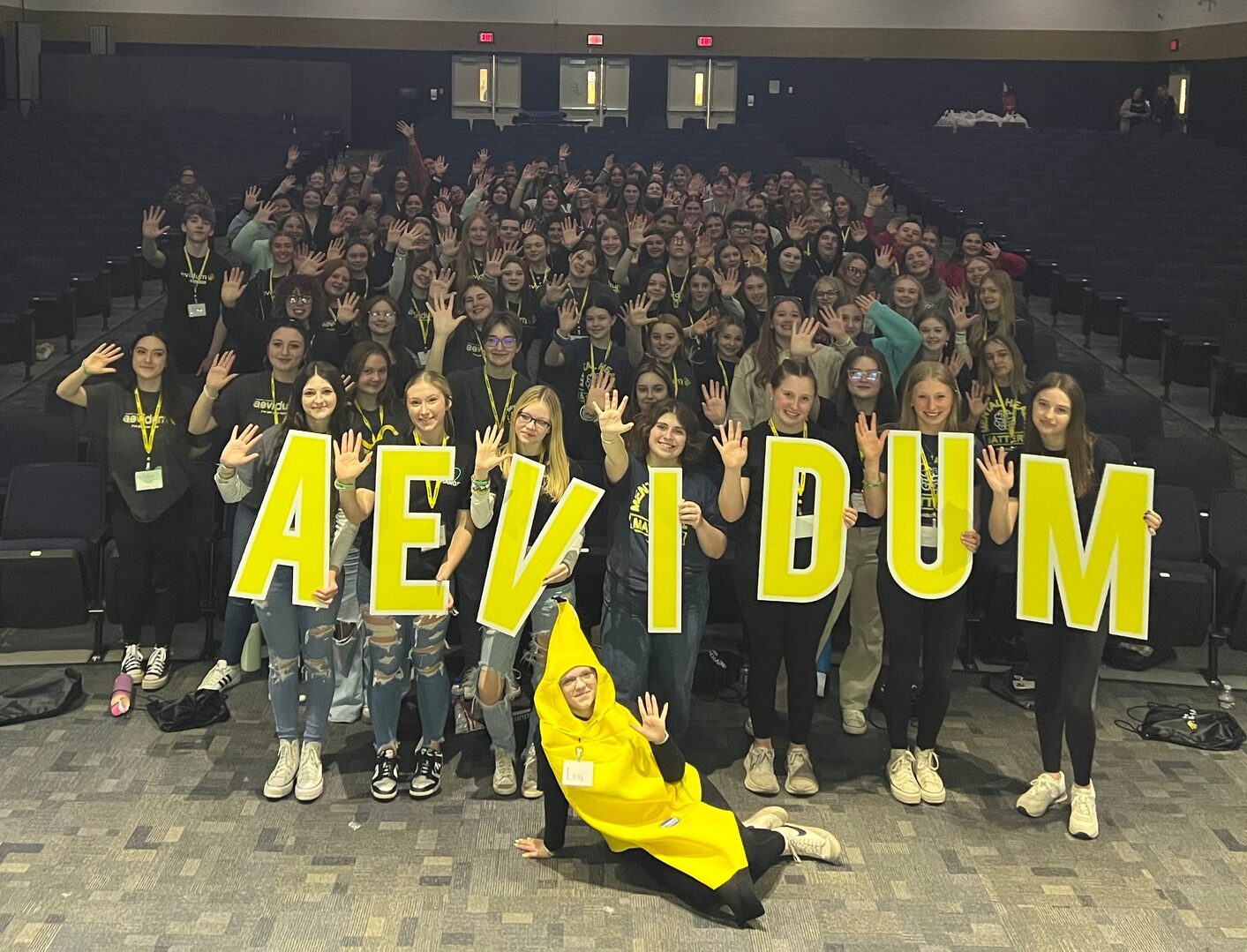 group of students holding an Aevidum sign